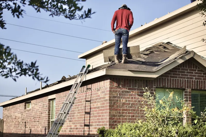 Professional roofer working on a residential roof in Villages at Lynx Creek